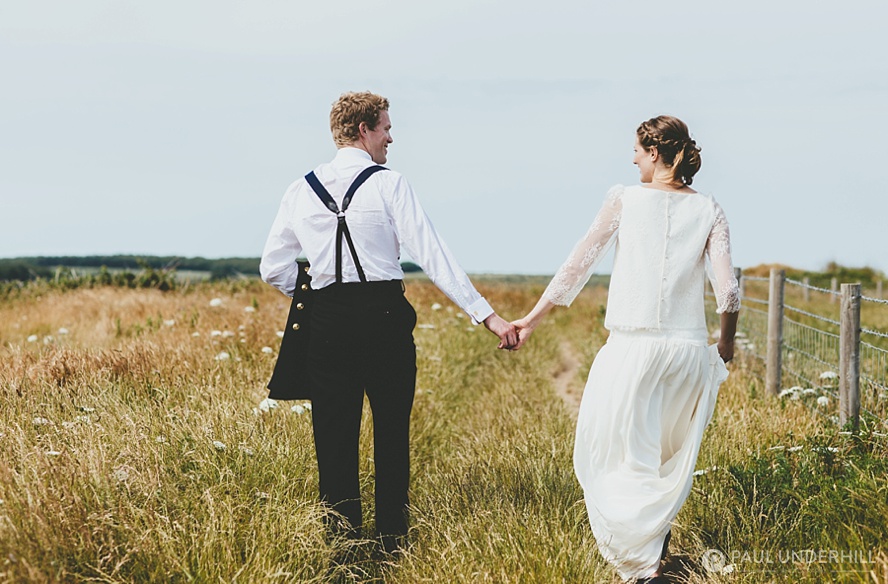Bride and groom hold hands