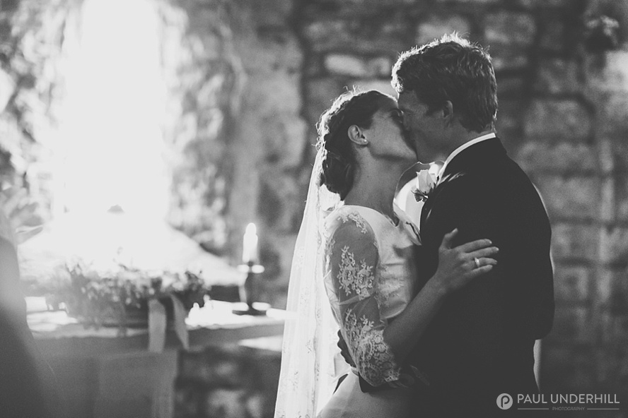 Bride and groom kiss St Aldhelms Chapel