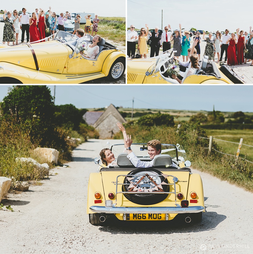Bride and groom wave as they drive off