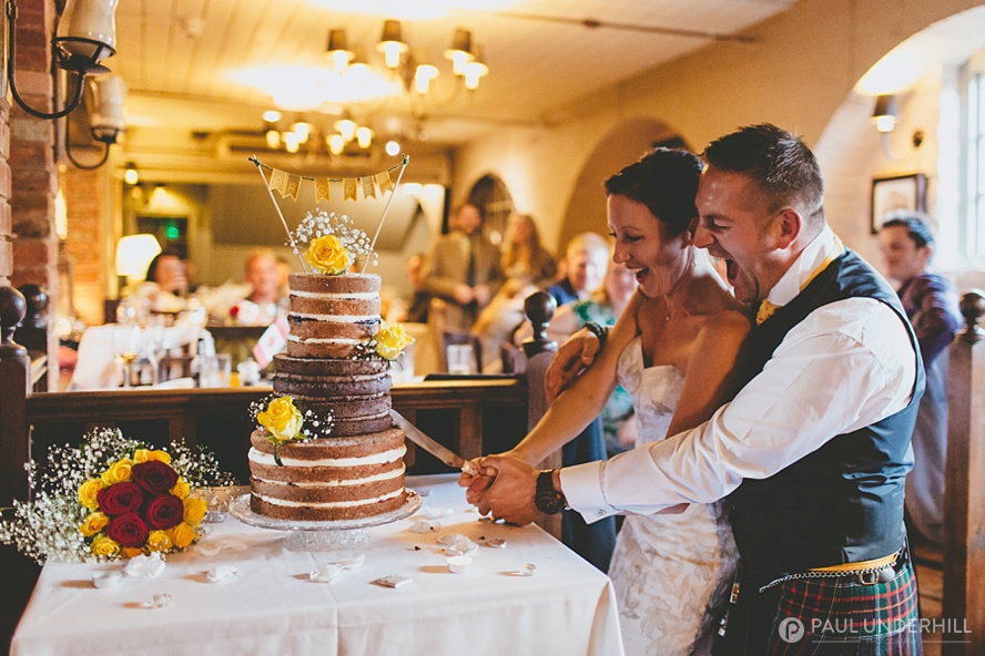 Bride and groom cut the cake