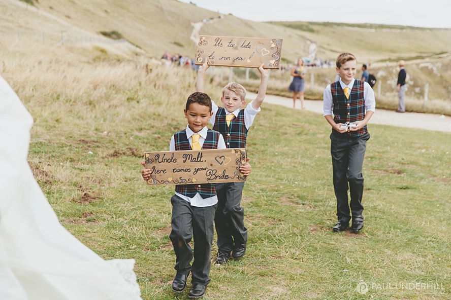 Page boys walk to the wedding